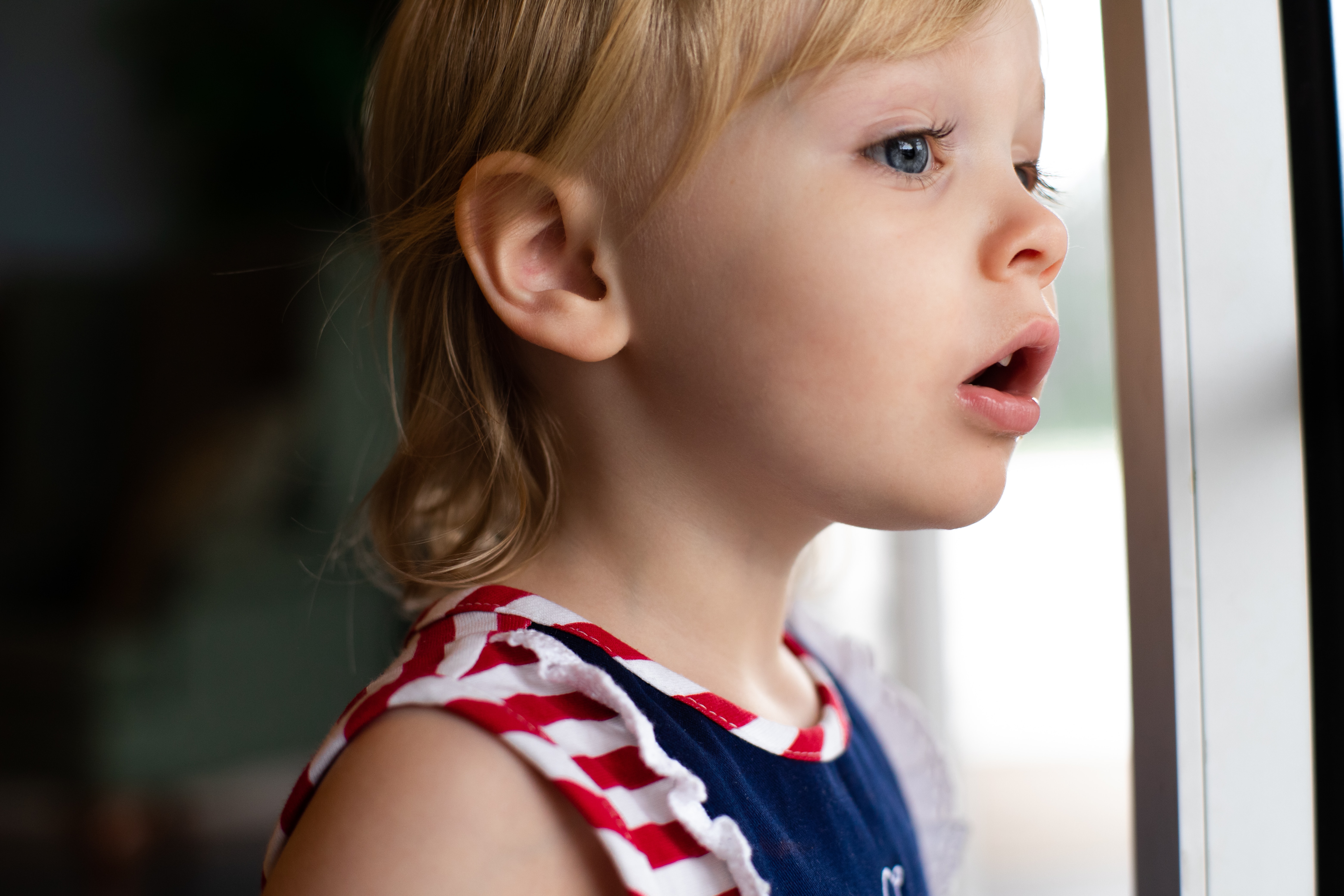 A child staring off into the distance, representing child welfare